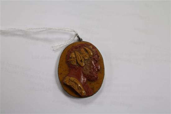 A 19th century red and yellow layered hardstone cameo carved with the head of a satyr, in pendant mount, 38mm.